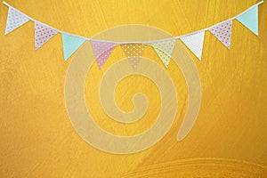 Bunting flag on blank yellow wall background