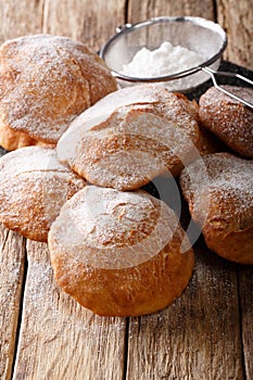 Bunuelos Mexican fritters sprinkled with powdered sugar close-up. vertical photo