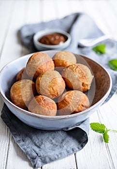 Bunuelos - traditional Colombian deep fried pastry with chocolate sauce