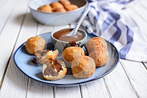 Bunuelos - traditional Colombian deep fried pastry with chocolate sauce photo