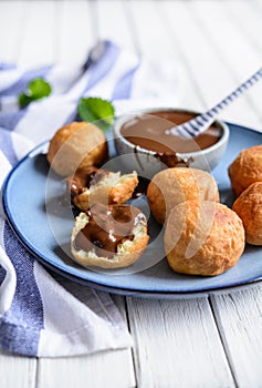 Bunuelos - traditional Colombian deep fried pastry with chocolate sauce photo