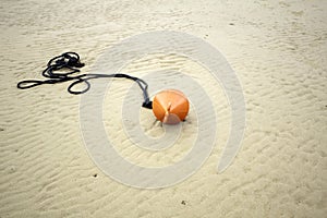 Buoy on beach sand