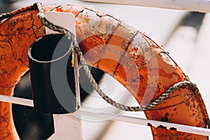 Buoy or lifebuoy ring on shipboard in evening sea. Flotation device on ship side on seascape. Safety, rescue, life