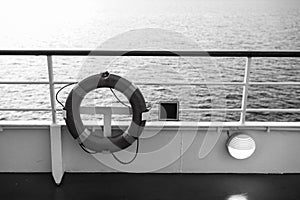 Buoy or lifebuoy ring on shipboard in evening sea in miami, usa. Flotation device on ship side on seascape. Safety