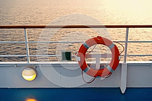 Buoy or lifebuoy ring on shipboard in evening sea in miami, usa. Flotation device on ship side on seascape. Safety