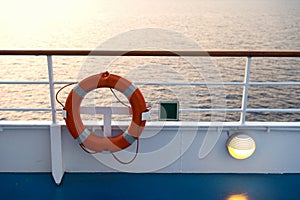 Buoy or lifebuoy ring on shipboard in evening sea in miami, usa. Flotation device on ship side on seascape. Safety, rescue, life p