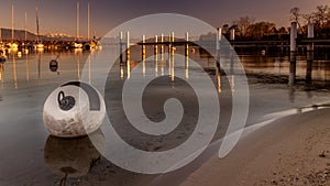 Buoy and pontoon at sunset