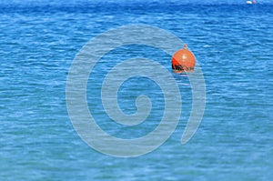 Buoy at right side on blue ocean like emergency sign