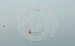 Buoy with yacht in the fog. Mist over the sea. Ship in the fog. Yacht parking Sea port.