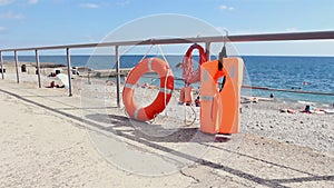 Buoyancy equipment for rescuing drowning people on the seashore. Lifebuoy and life jacket on the beach