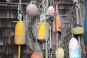 Buoys hanging on weathered wall with netting