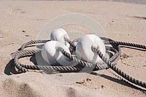 Buoys and rope on the sand