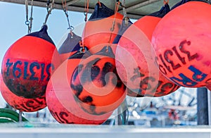 Buoys tied to side of a fishing boat. Colorful buoys hanging on a fishing boat