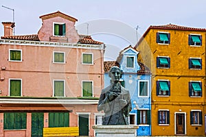 Burano houses, Italy, Venice. Piazza Baldassarre Galuppi monument