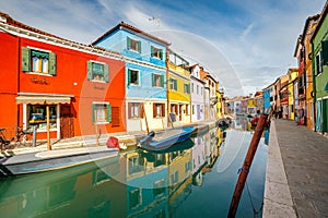 The Burano island near Venice, a canal between colorful houses