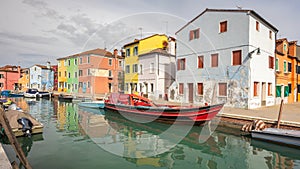 The Burano island near Venice, a canal with colorful houses