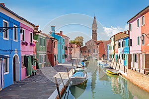 Burano, Italy with colorful painted houses along canal with boats