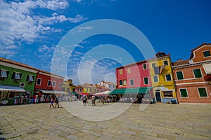 BURANO, ITALY - JUNE 14, 2015: Big square at Burano, little houses of colors and turists everywhere