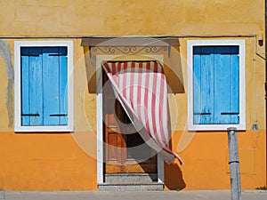 Burano, Venezia, Italy. Details of the windows and doors of the colorful houses in Burano island