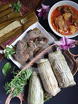 Burasak or buras with chicken curry and rendang. famous Bugis food during eid