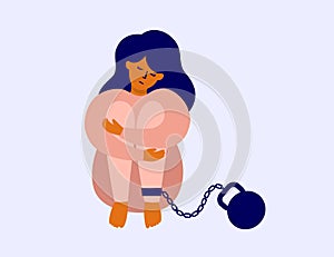 Burden of responsibility, debt, guilt with sad woman chained with weight sitting hugging her knees photo