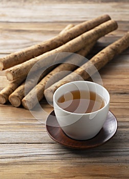 Burdock tea on a wooden board in the background photo