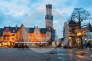 Burg Square at sunset with puddles after the rain. Bell Tower in the background. Bruges  Belgium