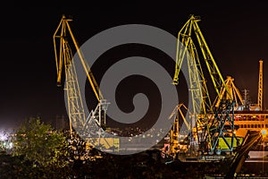 Burgas, Bulgaria - August 26, 2015 21:29h : Cargo cranes on the coast of Fish port of Burgas, Bulgaria