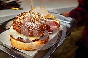 Burger with beef, cheese and fries. Close-up, selective focus