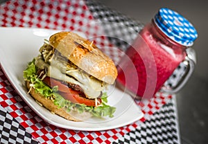 Burger with cheese tomato and a drink photo