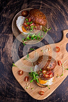 Burger with cherry tomato, green sprout and fried egg