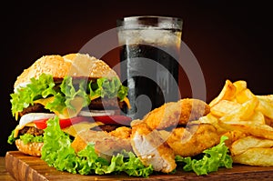 Burger, chicken nuggets, french fries and cola drink