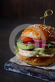 Burger with chicken and vegetables cooked on the grill, homemade pastries, healthy, natural food