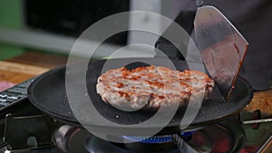 Burger cutlet on metal pan. Background, succulent.