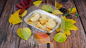 Burger and french fries on wooden background with autumn leaves,fast food concept, take away food concept, season sales