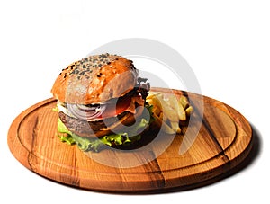 Burger with french fries on a wooden board. Fast food isolated on white background