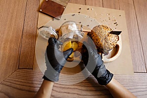 A burger and french potato on a wooden table background. A set of fast food dishes on a wooden tray, close-up. Copy