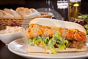 Burger with golden crumbed chicken breast photo