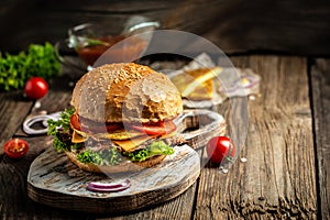 Burger with potato pancakes and meat on wooden vintage table. American food concept. fast food meal. banner, menu, recipe, place