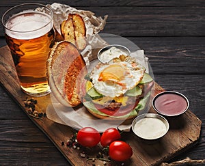 Burger and potatoes served with beer at restaurant