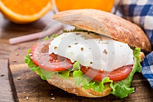 Burger with pouched egg and tomato