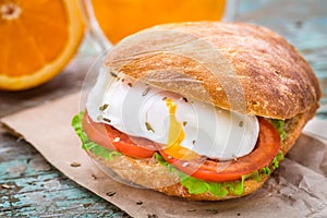 Burger with pouched egg and tomato