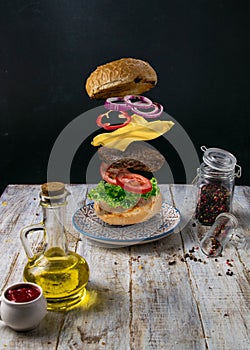 The burger`s appearance is different. Filing on a white wooden background.