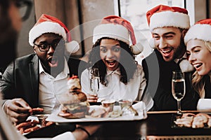 Burger. Santa`s Hat. Girls and Guys. Young People.