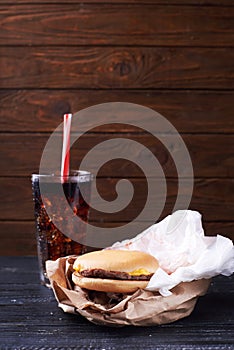 Burger served with glass with ice cola drink
