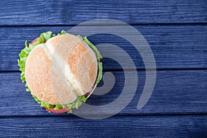 Burger on wooden table top view