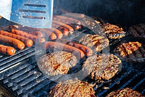 Burgers and dogs on the grill photo