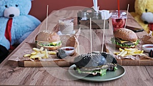 Burgers and Fries on Cafe Table, Family Meal