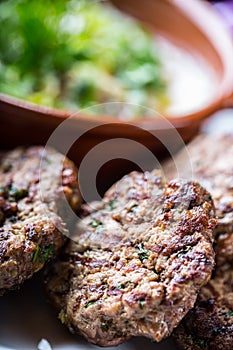 Burgers. Grill burgers. Minced burgers. Roasted burgers with grilled vegetable and herb decoration. Minced meat grilled in a hotel