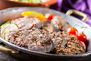 Burgers. Grill burgers. Minced burgers. Roasted burgers with grilled vegetable and herb decoration. Minced meat grilled in a hotel